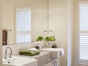 Cream Bathroom with Granite Counter Top and Window and Mirror and Plant and Towel